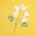 Detailed view of handmade crochet pansy flowers showing intricate soft wool texture - Yellow