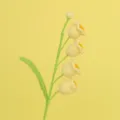 Macro view of delicate hand-knitted yellow crochet lily of the valley flowers and leaf - Four-Head Lily of the Valley Branch (Finished) / Yellow