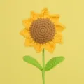 Close-up of a handmade crochet sunflower with intricate yellow knitted petals. - 6 Rings With Double Leaves / Single Stem Length 30cm