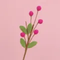 Detailed close-up of hand-crocheted pink berry branch with vibrant green leaves for home decor - Rose Red