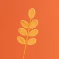 Primo piano di un ramo di foglie all'uncinetto fatte a mano in filato arancione vivo - Ramo di Foglie a 7 Foglie per Tutte le Stagioni / Giallo