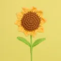 Detail of a handmade crochet sunflower with textured brown center and green stem. - 5 Rings With Double Leaves / Single Stem Length 30cm