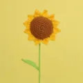 Macro detail of a single handmade yellow crochet sunflower featuring intricate stitch work - 7 Rings With Single Leaf