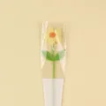 Detailed view of a handmade crochet puff flower inside romantic "LOVE" gift packaging - Large Puff Flower (Double Leaf) With Bag / Yellow