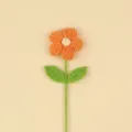 Close-up of handmade orange crochet puff flower with green leaves for home decor - Large Puff Flower (Double Leaf) / Orange