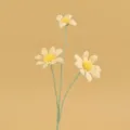 Detailaufnahme von drei zarten handgehäkelten gelben Gänseblümchen für die Deko - Gelb