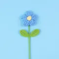 Macro view of a handcrafted blue crochet puff flower with intricate knit texture. - Large Puff Flower (Double Leaf) / Blue
