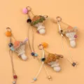 Handmade crochet mushroom keychain charms with colorful pom-poms and decorative beads - Brown