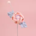 Macro detail of a handmade pink crochet peony flower with delicate lavender leaves - Light Pink