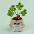 Close-up of a handmade crochet emotional plant with a motivational message card. - Four-Leaf Clover / Medium Smile Pot (Beige) / Green