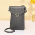 Elegant gray PU leather touchscreen crossbody phone bag featuring a gold heart buckle - Dark Gray