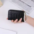 Elegant black crocodile pattern PU leather short wallet featuring a pearl wristlet strap - Black