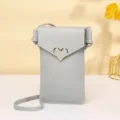 Light grey minimalist PU leather phone bag with golden heart clasp and adjustable strap. - Light Gray