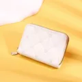 Detail macro view of a stylish white women's short wallet with quilted heart patterns and zip - White