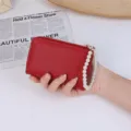 Compact red lychee pattern leather mini wallet with elegant pearl wristlet strap - Red