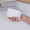 Minimalist white lychee grain coin purse featuring a stylish faux pearl wristlet chain - White
