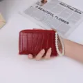 Women's red short bifold wallet with faux-crocodile pattern and white pearl strap - Red