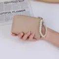 Minimalist beige lychee grain coin purse for women with elegant white pearl wristlet strap - Apricot