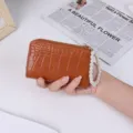 Brown crocodile pattern short wallet for women featuring elegant pearl wristlet strap - Brown