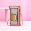 Detailed view of the pink crossbody phone bag featuring a transparent touch screen window. - Pink