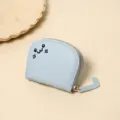 Detailed macro shot of light blue cat-shaped coin purse with embroidered face and tail zipper. - Blue