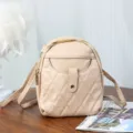 Beige quilted mini crossbody bag in soft faux leather with elegant diamond lattice pattern - Apricot
