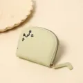 Close-up of cute green cartoon cat coin purse with embroidered face and tail zipper - Matcha Green