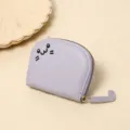Detailed view of lavender cartoon cat coin purse with embroidered face and tail zipper. - Purple