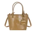 Vintage glossy tan bucket tote bag with decorative pouch charm and adjustable strap - Khaki