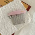 Detail view of pink acetate hair comb with metal teeth and France Handmade engraving - Pink