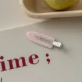 Close-up of a cute pink hair clip with white heart patterns and 'Fancy' text on a card - Light Pink Heart Polka Dot