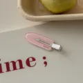 Macro detail of a pink polka dot duckbill hair clip with decorative Spring text print - Pink Round Polka Dot