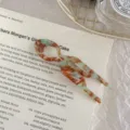 Close-up detail view of acetate U-shaped hair fork with mint green and brown marble pattern - Green Brown Pattern - Large