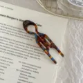 Macro view of a U-shaped acetate hair stick with tortoiseshell and blue marble patterns - Lake Blue Brown - Large