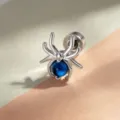 Einzigartiger spinnenförmiger Piercing-Stecker mit blauer Perle aus glänzendem Titanstahl. - Seeblauer Stil (Titanlegierung Außenschraube)