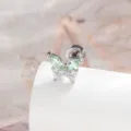 Macro view of titanium butterfly stud earring with sparkling green and clear gems - Outer Spiral Style (A-243) / Mint Green