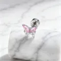Close-up of pink butterfly surgical steel stud earring on white marble base - Stainless Steel Outer Spiral Style (A-243) / Pink