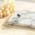 Close-up of star-shaped blue zircon earring with silver wing detail on marble. - Left Side Style (A-1005) / Stainless Steel External Spiral / Light Sea Blue