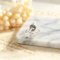 Detail of silver-tone star and wing stud earring with sparkling zircon on marble - Left Side Style (A-1005) / External Screw / White