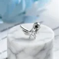Macro detail of minimalist silver star zircon wing earring on white marble display - Right Side Style (A-1005) / Stainless Steel External Spiral / White