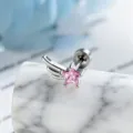Close-up macro view of a pink star zircon wing stud earring on a marble pedestal - Right Side Style (A-1005) / Stainless Steel External Spiral / Pink