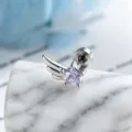 Macro view of purple star zircon and silver wing design on a minimalist stud earring - Right Side Style (A-1005) / External Screw / Blue and Purple