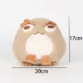 Detalle de un cojín de peluche de sapo beige de 17x20cm con marcas de dimensiones. - Tostado