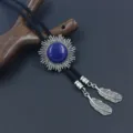 Close-up of retro cowboy bolo tie with blue gemstone sun pendant - Lapis Lazuli