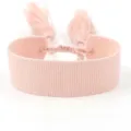 Close-up detail of a soft pink woven textile bracelet with tassels for DIY embroidery - Pink (B135)