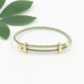 Adjustable pink and green braided wire rope bracelet with gold-toned slider buckles - Pink Green