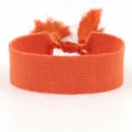 Vibrant orange woven fabric bracelet with tassel detail, perfect for DIY embroidery - Orange (B247)