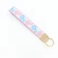 Close-up of jacquard floral embroidery on a white fabric wristlet keychain strap - White Base with Pink Blue Flowers and Pink Lace (04-04B)