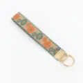 Close-up of ethnic floral embroidered jacquard wristlet keychain with gold metal ring - Retro Orange and Green Flowers (04-04C)