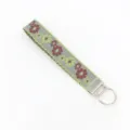 Detailed view of vintage ethnic jacquard woven wristlet keychain with floral embroidery - Gray Ribbon with Green Trim and Red Yellow Flowers (04-04E)